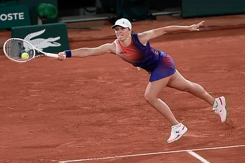Iga Swiatek plays a shot against Naomi Osaka